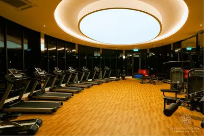 a gym with rows of treadmills and a large ceiling at Trion Kuala Lumpur by Five Senses in Kuala Lumpur