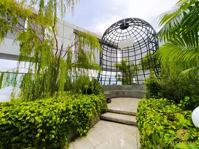 a garden with a bird cage and some plants at Trion Kuala Lumpur by Five Senses in Kuala Lumpur
