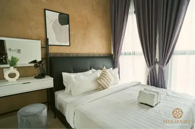 a bedroom with a large bed and a window at Trion Kuala Lumpur by Five Senses in Kuala Lumpur