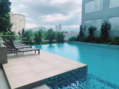 a swimming pool with a bench and a building at The Nova by The City Collection II in Kuala Lumpur
