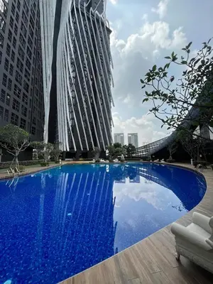 a large blue swimming pool in front of tall buildings at Regalia Resident by Great Stay in Kuala Lumpur