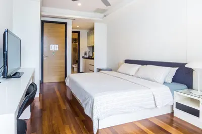 a bedroom with a white bed and a television at Yelloduck Rooms & Apartment @ Casa Residency in Kuala Lumpur