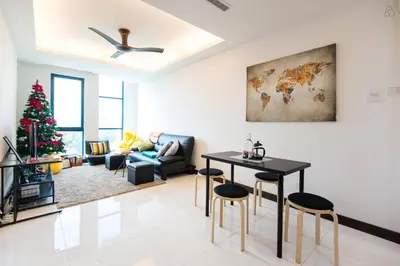 a living room with a christmas tree and a table and chairs at Yelloduck Rooms & Apartment @ Casa Residency in Kuala Lumpur