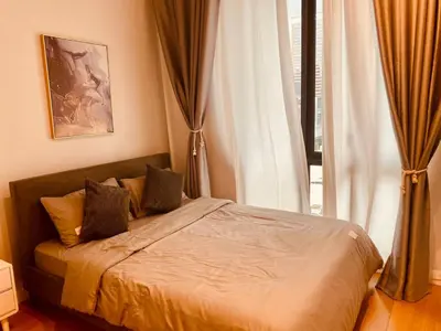 a bedroom with a bed with curtains and a window at Sentral Suites Kuala lumpur By Leyla 3BR suites 8 pax in Kuala Lumpur