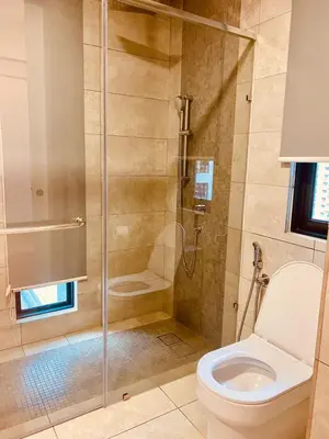 a bathroom with a glass shower with a toilet at Sentral Suites Kuala lumpur By Leyla 3BR suites 8 pax in Kuala Lumpur