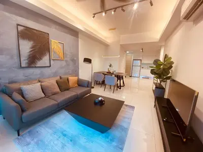 a living room with a couch and a table at Sentral Suites Kuala lumpur By Leyla 3BR suites 8 pax in Kuala Lumpur