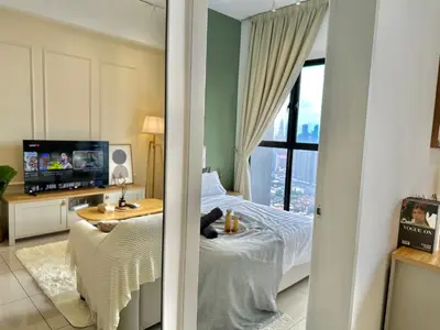 a bedroom with a bed and a television in a room at Trion KL 10mins to KLCC-Lalaport-Velocity 6 Pax in Kuala Lumpur