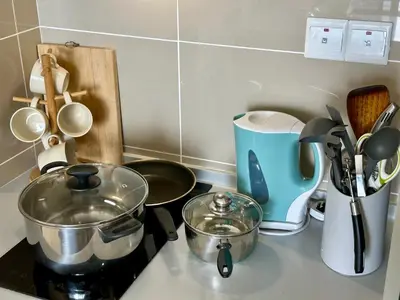 a kitchen counter with pots and pans on a stove at Trion KL 10mins to KLCC-Lalaport-Velocity 6 Pax in Kuala Lumpur