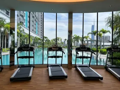 a gym with a swimming pool in a building at Trion KL 10mins to KLCC-Lalaport-Velocity 6 Pax in Kuala Lumpur