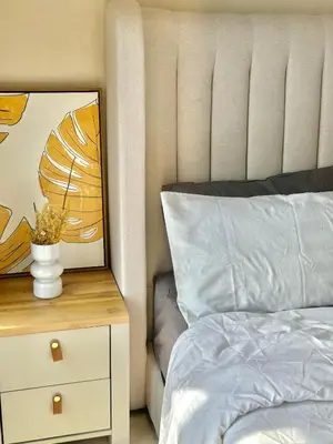 a bedroom with a bed and a vase on a night stand at Trion KL 10mins to KLCC-Lalaport-Velocity 6 Pax in Kuala Lumpur
