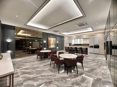 a lobby with tables and chairs and a kitchen at Luxury 2BR KL View, Infinity Pool, Walk to Pavilion and Jalan Alor in Kuala Lumpur