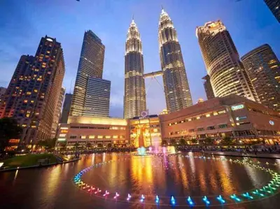 a city with a fountain in the middle of a city at Cozy Duplex Studio near Kuala Lumpur next to LRT Train Station in Ampang