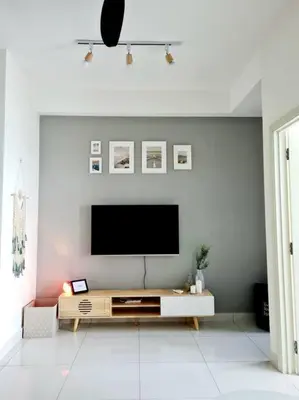 a living room with a flat screen tv on a wall at Best Affordable Homestay, Arte Mont Kiara, KL in Kuala Lumpur