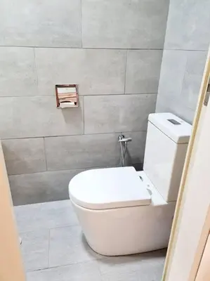 a bathroom with a white toilet in a room at Best Affordable Homestay, Arte Mont Kiara, KL in Kuala Lumpur