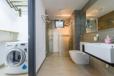 a bathroom with a washing machine and a sink at Cozy KL Sunway Velocity Residence for 1-5pax connected to MRT & Malls in Kuala Lumpur