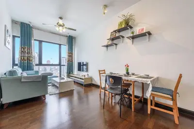 a living room with a table and chairs and a couch at Cozy KL Sunway Velocity Residence for 1-5pax connected to MRT & Malls in Kuala Lumpur