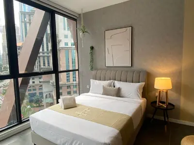 a bedroom with a large bed and a large window at Luxury Apartment at Scarletz Suites Kuala Lumpur in Kuala Lumpur