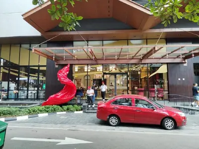 a red car parked in front of a building at Luxury Apartment at Scarletz Suites Kuala Lumpur in Kuala Lumpur