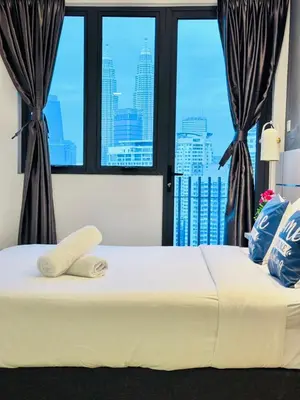 a large white bed with a view of a city at The Luxe Infinitum Sky pol KLCC in Kuala Lumpur