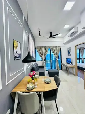 a dining room and living room with a table and chairs at The Luxe Infinitum Sky pol KLCC in Kuala Lumpur
