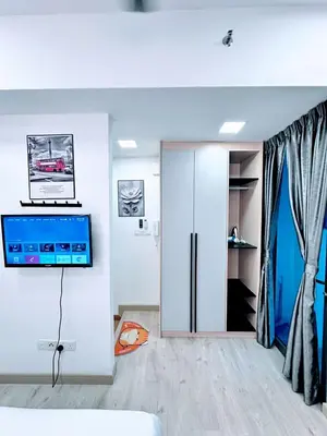 a room with a sliding door with a tv on the wall at The Luxe Infinitum Sky pol KLCC in Kuala Lumpur