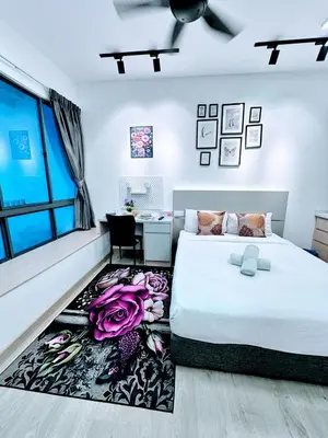 a bedroom with a white bed and a desk and a window at The Luxe Infinitum Sky pol KLCC in Kuala Lumpur