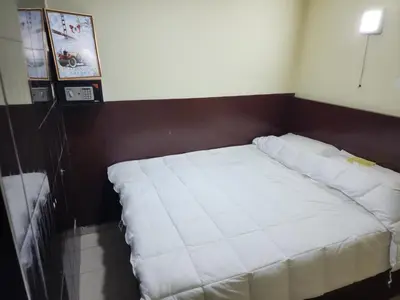 a bed in a room with a white mattress at 24Seven Guesthouse in Kuala Lumpur