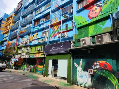 a building with a mural on the side of it at 24Seven Guesthouse in Kuala Lumpur