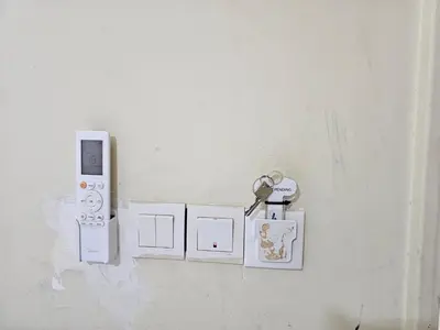 a wall with a bunch of keys on a wall at 24Seven Guesthouse in Kuala Lumpur