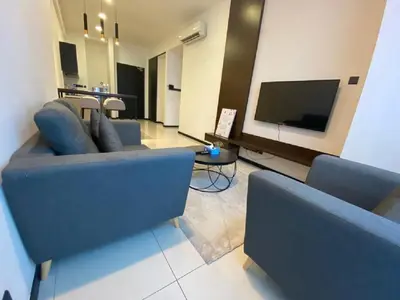 a living room with two blue couches and a tv at Kuala Lumpur Apartment at Opus Residence Near China Town and 118 Tower in Kuala Lumpur