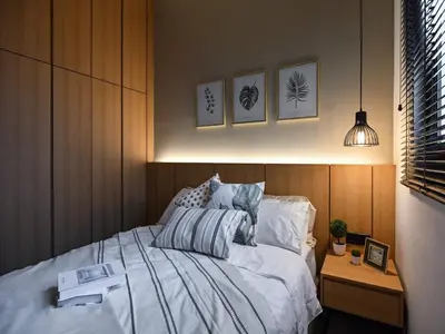 a bedroom with a bed with white sheets and a table at Kuala Lumpur Apartment at Opus Residence Near China Town and 118 Tower in Kuala Lumpur