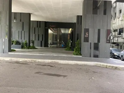 a building with a parking lot in front of it at Kuala Lumpur Apartment at Opus Residence Near China Town and 118 Tower in Kuala Lumpur