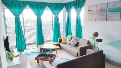 a living room with blue curtains and a couch at 3A YOLO Budget Condo in Kuala Lumpur