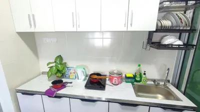 a kitchen counter with a sink and dishes on it at 3A YOLO Budget Condo in Kuala Lumpur