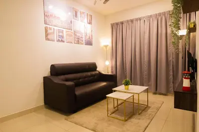 a living room with a couch and a table at KL 9Pax 10Mins to Sentul LRT, Batu Caves, MCD (Zena Suites) in Kuala Lumpur