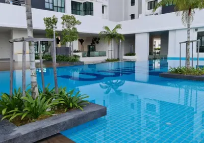 a large swimming pool with blue tiles in a building at KL 9Pax 10Mins to Sentul LRT, Batu Caves, MCD (Zena Suites) in Kuala Lumpur