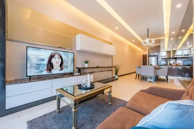 a living room with a flat screen tv on a wall at Dorsett Residence Kuala Lumpur \u5e1d\u76db\u516c\u5bd3 Bukit Bintang in Kuala Lumpur