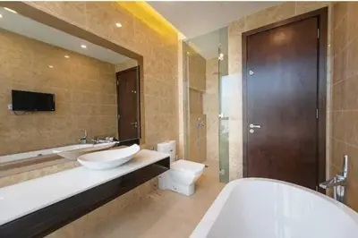 a bathroom with two sinks and a tub and a toilet at Dorsett Residence Kuala Lumpur \u5e1d\u76db\u516c\u5bd3 Bukit Bintang in Kuala Lumpur