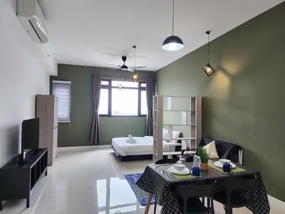 a living room with a bed and a table and chairs at Chambers Residences Suites KLCC in Kuala Lumpur
