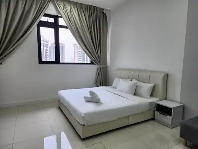 a bedroom with a white bed with a window at Chambers Residences Suites KLCC in Kuala Lumpur