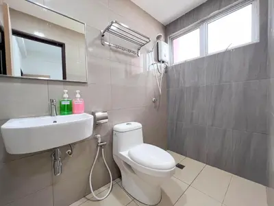 a bathroom with a white toilet and a sink at Maison Signature Suites in Kuala Lumpur