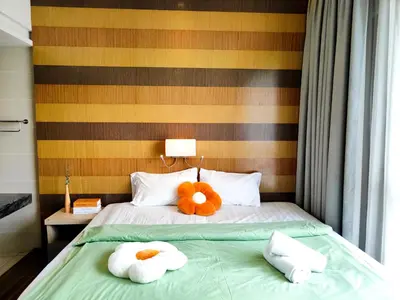 a bedroom with a bed with two stuffed animals on it at D'Majestic Place Jalan Pudu in Kuala Lumpur