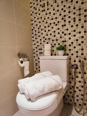 a bathroom with a toilet with towels on it at D'Majestic Place Jalan Pudu in Kuala Lumpur