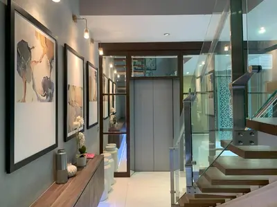 a staircase in a house with a glass entry way at KL Golf Country Club Resort Villa by AnyLodge in Kuala Lumpur