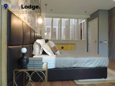 a bedroom with a large bed and a table at KL Golf Country Club Resort Villa by AnyLodge in Kuala Lumpur