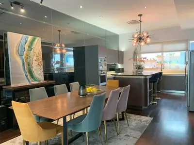 a kitchen and dining room with a wooden table and chairs at KL Golf Country Club Resort Villa by AnyLodge in Kuala Lumpur