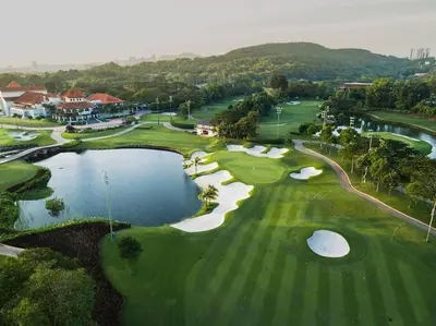 an aerial view of a golf course with a pond at KL Golf Country Club Resort Villa by AnyLodge in Kuala Lumpur