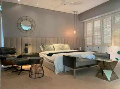 a bedroom with a large bed and a chair at KL Golf Country Club Resort Villa by AnyLodge in Kuala Lumpur