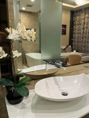 a bathroom sink with a faucet on a counter at The Dorsett Service Suites Bukit Bintang Kuala Lumpur in Kuala Lumpur