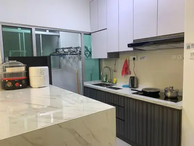 a kitchen with white cabinets and a counter top at Corner KL Pool View RC Residence with High Internet Speed 500Mbps in Kuala Lumpur